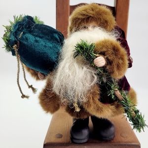 Santa Claus holding a Tree and a Bag of Toys